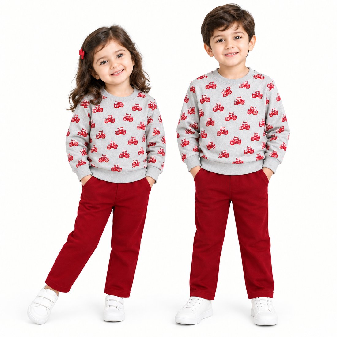 A two-piece children's sweatshirt and jogger set on a white background. The sweatshirt is light gray with a repeating pattern of small red tractors, and the jogger pants are a solid deep red.
