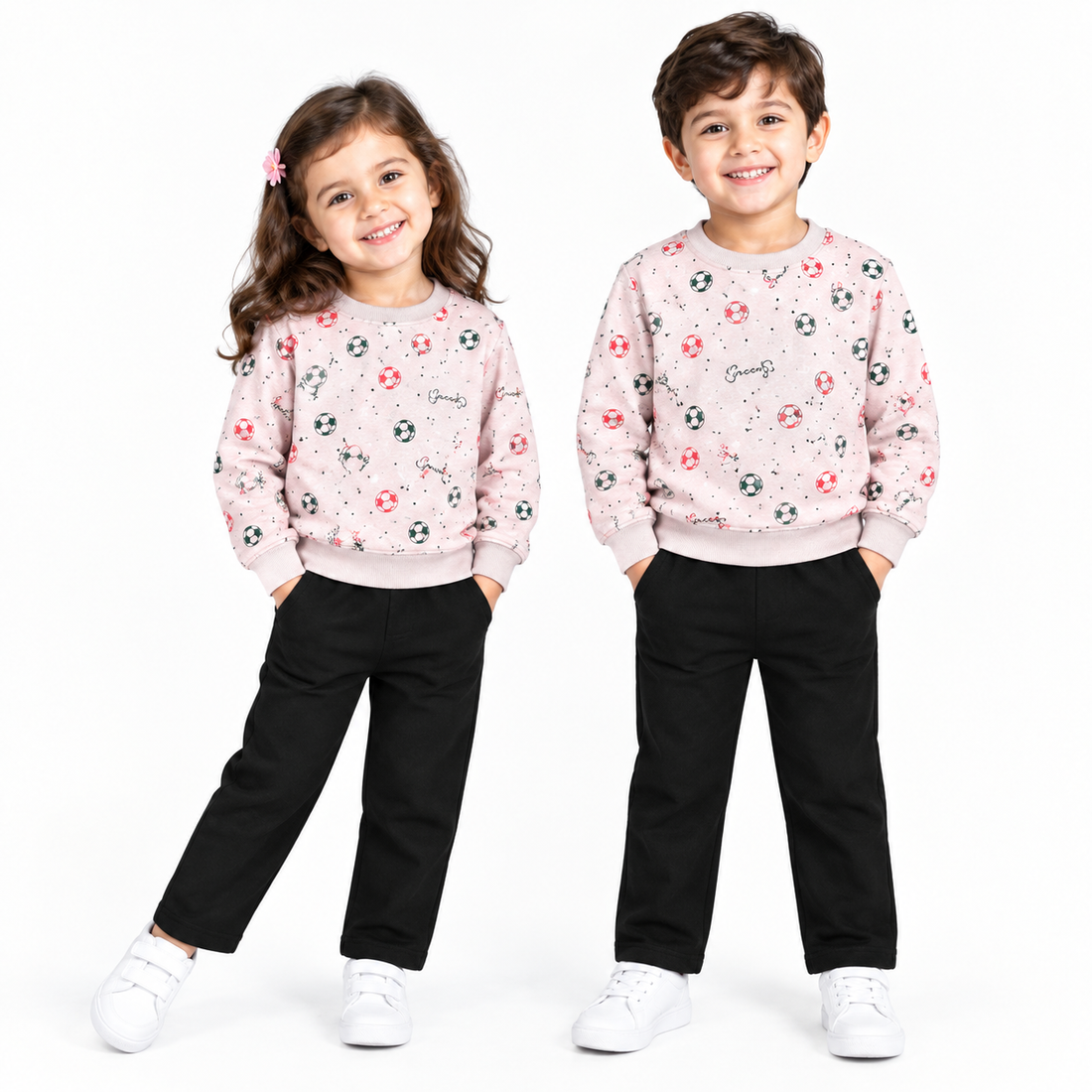 A children's two-piece outfit set featuring a light pink long-sleeve sweatshirt with a pattern of keys, soccer balls, and life preservers, paired with solid black pants, shown on a plain white background.