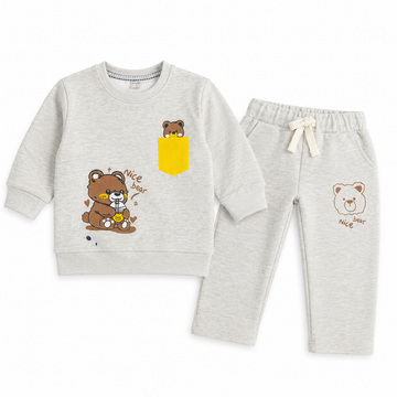 A two-piece kids' loungewear set consisting of a light heather gray sweatshirt and matching jogger pants. The sweatshirt features a brown cartoon bear graphic with a yellow pocket detail on the left chest.